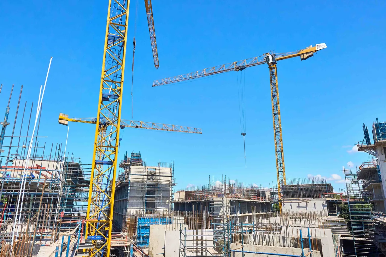 Tower cranes and scaffolding against a blue sky as construction gets under way at the Thrive Student Living student accommodation site in Berea, Durban
