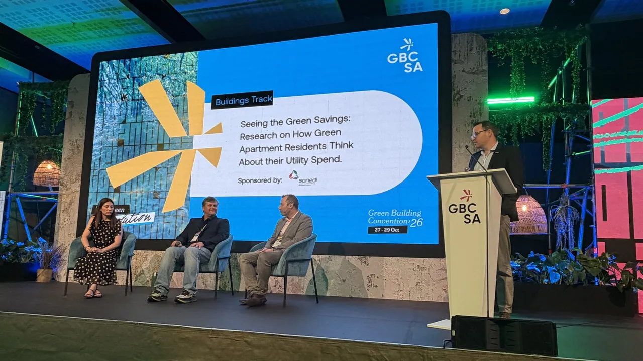 Three panellists seated and a speaker at the GBCSA lectern on stage at the Green Building Convention 2026, beneath a screen reading 'Seeing the Green Savings: Research on How Green Apartment Residents Think About their Utility Spend'