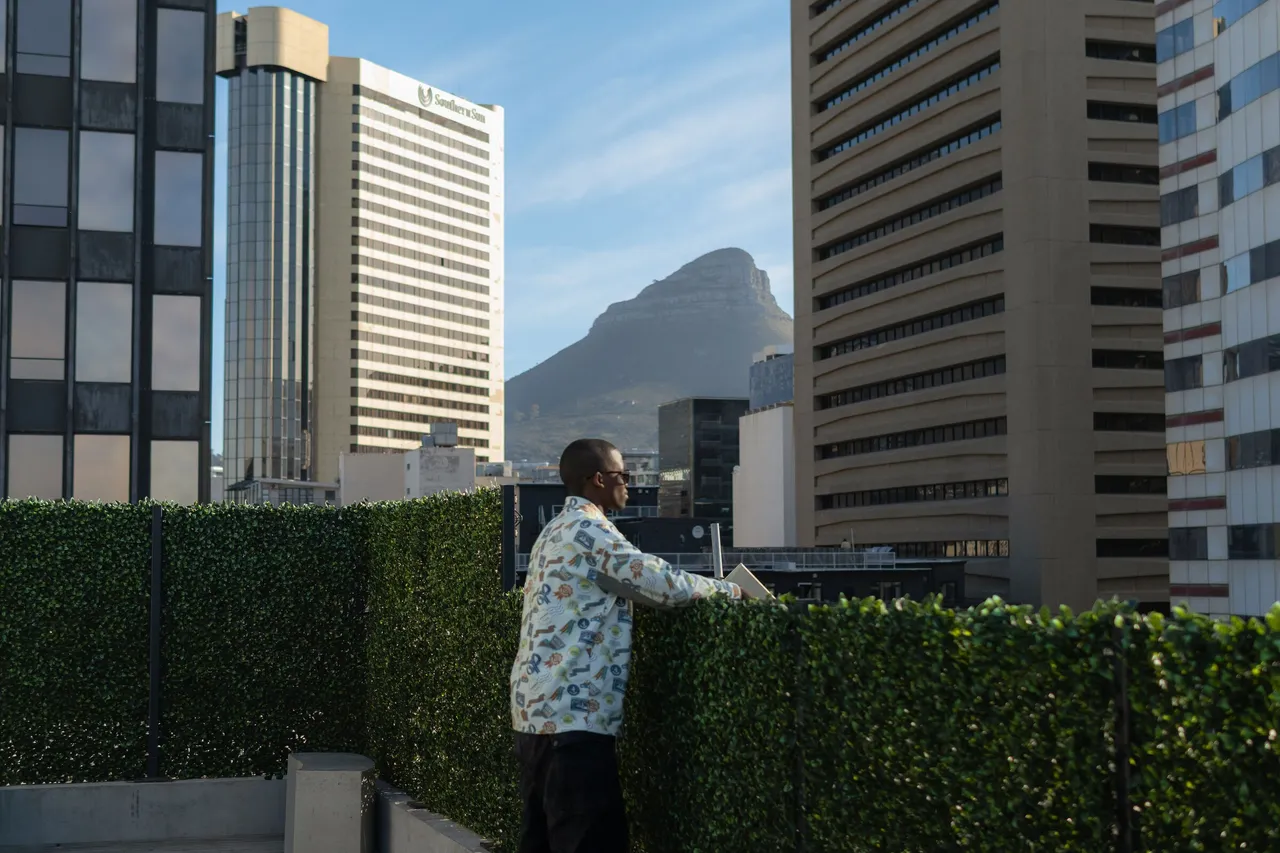 A guest on the rooftop at HAVN in the Cape Town city centre, looking out towards Lion’s Head